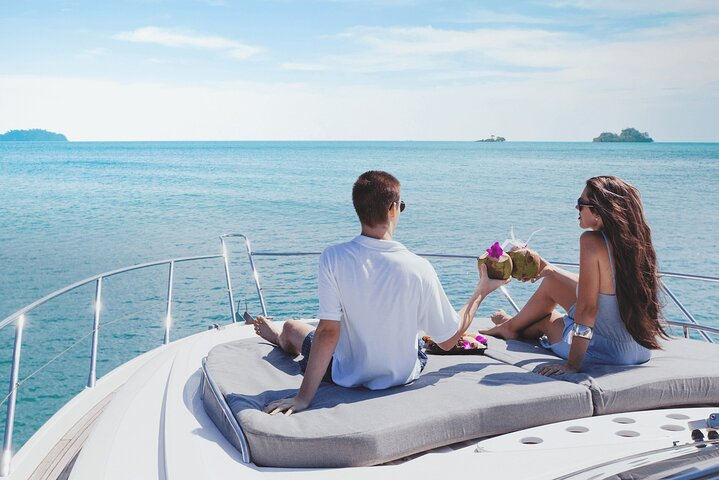 Savor the serene views of Dubai’s coastline while lounging on a luxurious yacht enjoying refreshing drinks and the company of fellow travelers creating lasting memories on this unique journey.